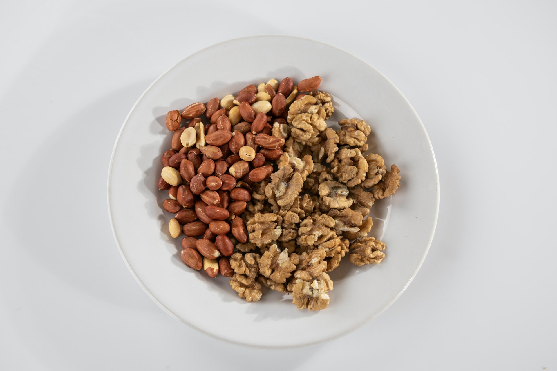 brown peanuts on white ceramic bowl